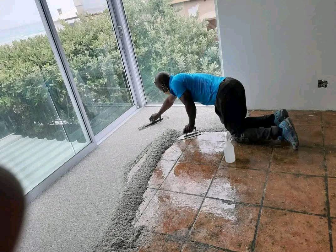 Installer applying quartz carpet indoors